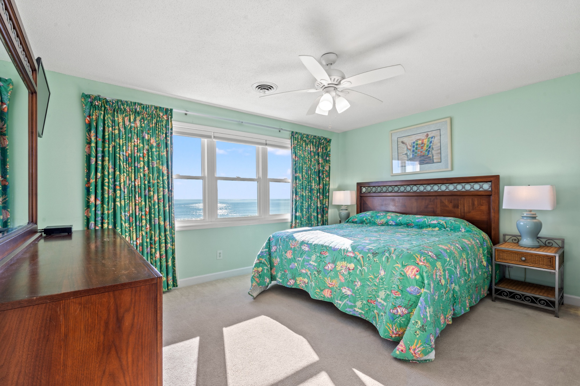 Primary bedroom with king bed and ocean view
